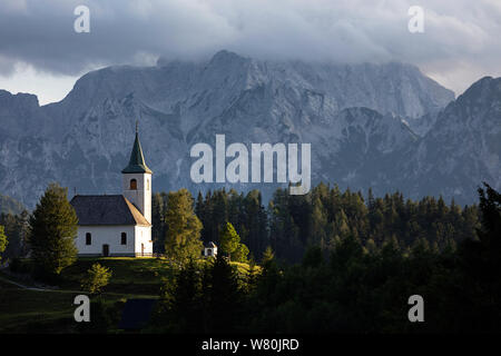 view over a Idyllic mountain scenery in the Alps with church from the panoramic Solcava road, Slovenia, Europe Stock Photo