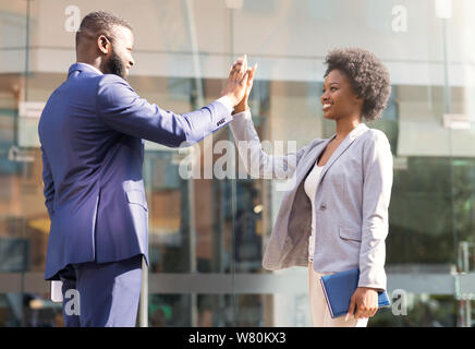 Good job partner. Businessman giving high five to his collegue Stock Photo
