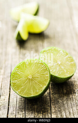 The green sliced lime on old wooden table. Stock Photo