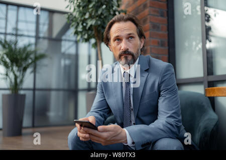 Businessman feeling thoughtful while waiting for the meeting Stock Photo