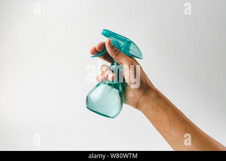 Hand holding plastic spray bottle - hold plastic spray bottle isolated on white. Man with water sprayer in hand. Stock Photo