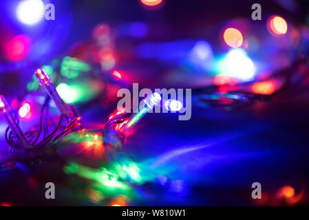 Christmas lights, Christmas background with glowing Garlands on black background, space for Text Stock Photo
