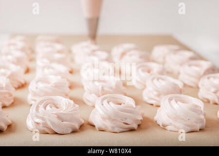 Meringue zephyr marshmallows on parchment paper top view Stock Photo