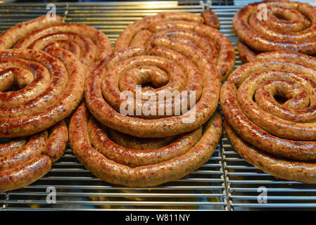 Sai Aua, traditional Northern Thai Spicy Sausage, stack and pile spiral shape of homemade Asian Spicy sausage in market. Stock Photo