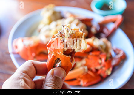 Fresh steamed or boiled crabs in plate on wooden table. Stock Photo
