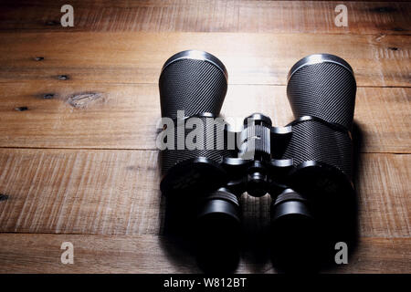 Binoculars on Rustic Wooden Background Stock Photo