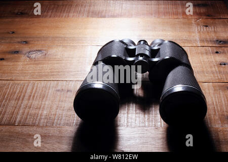 Binoculars on Rustic Wooden Background Stock Photo