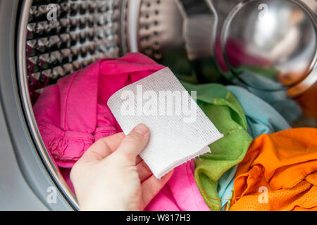 Color absorbing sheet inside a washing machine, allows to wash mixed color  clothes without ruining colors concept Stock Photo - Alamy