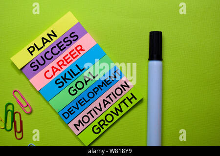 Career, Plan, Success, Skill, Goal, Development, Motivation, Growth text on sticky notes isolated on green desk. Mechanism Strategy Concept Stock Photo