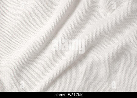 White woollen sweater, texture detail close up. Stock Photo