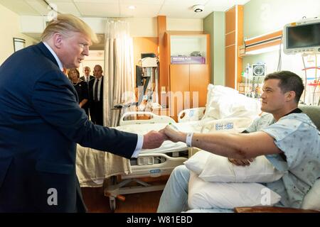 Dayton, United States Of America. 07th Aug, 2019. U.S President Donald Trump visits with a survivor at Miami Valley Hospital August 7, 2019 in Dayton, Ohio. Nine people were killed in a shooting in the Oregon District of Dayton, Ohio the day after 31 people were killed in mass shootings in El Paso. Credit: Planetpix/Alamy Live News Stock Photo