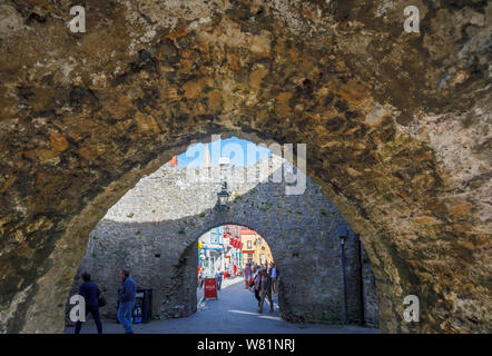 View of Tenby town centre through Five Arches Gate in its historic medieval city walls, a walled seaside resort in Pembrokeshire, south Wales coast Stock Photo