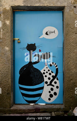 Two enamored hungry cats dreaming of fish. Painted door in Groznjan/ Grisignana, Istria, Croatia, Europe Stock Photo