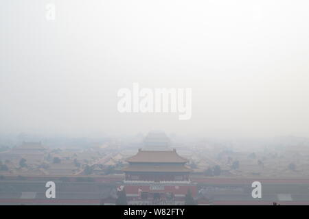 This composite photo shows the Palace Museum, also known as the Forbidden City, and the National Centre for the Performing Arts in heavy smog in Beiji Stock Photo