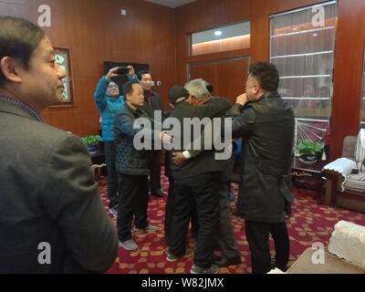 Chinese veteran soldier Wang Qi, second right, who was unable to leave India for 54 years, hugs his family after returning to homeland at the Xi'an Xi Stock Photo