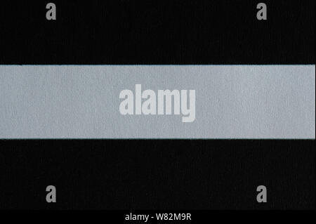 White line on black paper background macro close up view Stock Photo