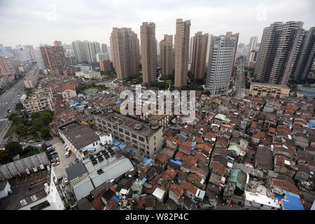--FILE--An aerial view of a shantytown with old houses next to clusters of modern high-rise residential apartment buildings in Shanghai, China, 11 Jan Stock Photo