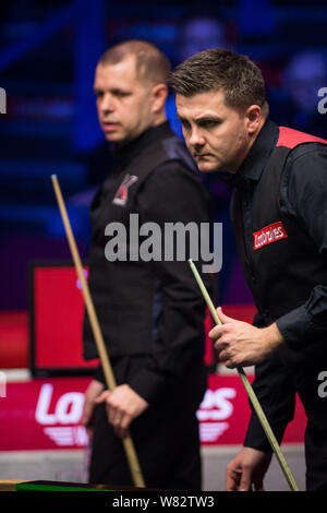 Barry Hawkins of England, left, watches as Ryan Day of Wales considers a shot in their final match during the World Grand Prix Snooker 2017 in Preston Stock Photo