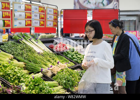 --FILE--Chinese customers shop for vegetables at a supermarket in Nanjing city, east China's Jiangsu province, 10 May 2016.   China's consumer prices Stock Photo