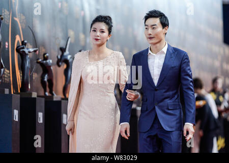 Chinese diving couple Qin Kai, right, and He Zi arrive at the red carpet for the China CCTV Sports Personality Awards of Year 2016 at the National Aqu Stock Photo