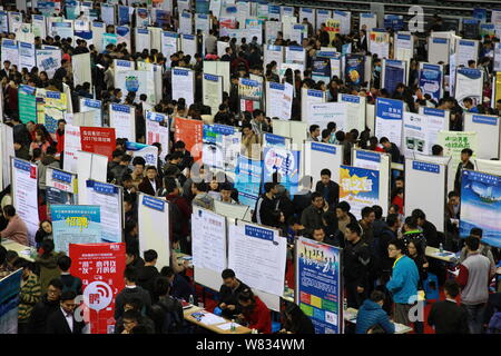 Chinese graduates crowd booths at a job fair during the Shanghai ...