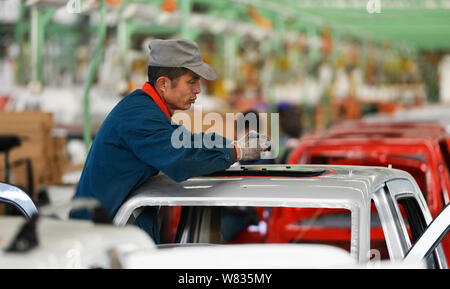 --FILE--A Chinese worker assembles cars on the assembly line at the ...