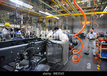 --FILE--Chinese workers assemble a truck on the assembly line at an ...