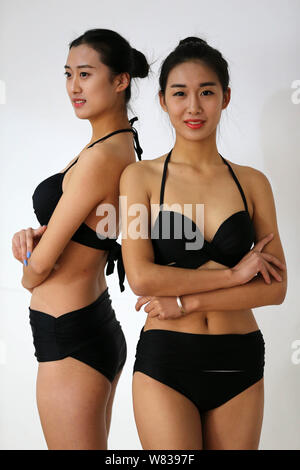 Bikini-dressed female high school students adjust bras during a