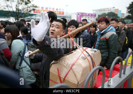 --FILE--A crowd of Chinese passengers queue up to enter the Guangzhou Railway Station before the Chinese New Year holiday during the Spring Festival t Stock Photo