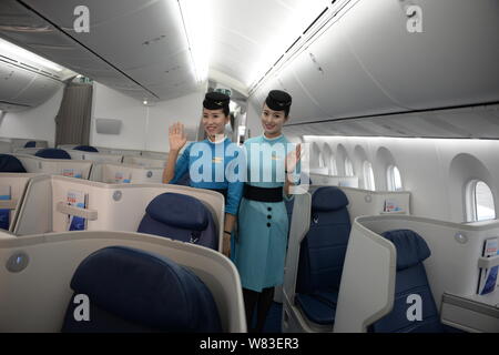 Chinese air hostesses pose in the business class of the first Boeing 787-9 Dreamliner of Xiamen Airlines at the Xiamen Gaoqi International Airport in Stock Photo