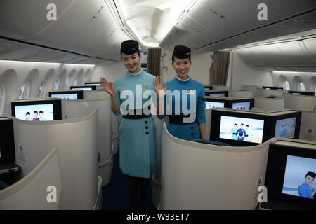 Chinese air hostesses pose in the business class of the first Boeing 787-9 Dreamliner of Xiamen Airlines at the Xiamen Gaoqi International Airport in Stock Photo