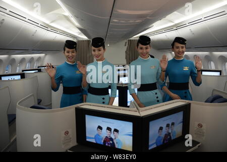 Chinese air hostesses pose in the business class of the first Boeing 787-9 Dreamliner of Xiamen Airlines at the Xiamen Gaoqi International Airport in Stock Photo