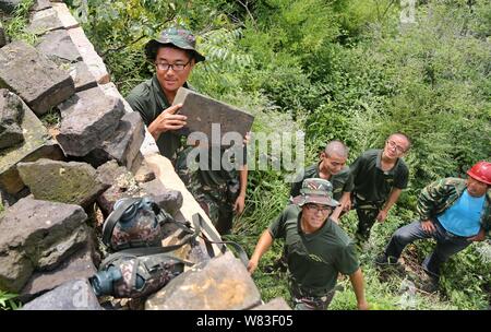 --FILE--Young Chinese volunteers preserve the Banchangyu Great Wall in Qinhuangdao city, north China's Hebei province, 25 July 2016.   The government Stock Photo