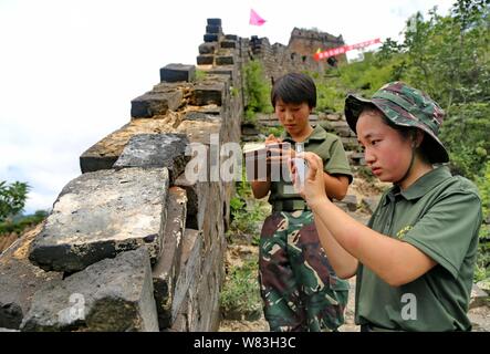 --FILE--Young Chinese volunteers preserve the Banchangyu Great Wall in Qinhuangdao city, north China's Hebei province, 25 July 2016.   The government Stock Photo