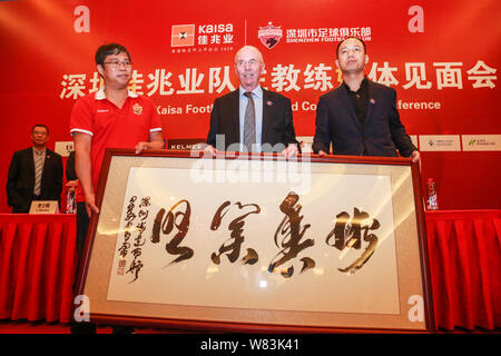 Sven-Goran Eriksson, center, the new head coach of China's Shenzhen Kaisa Football Club, poses with officials at a press conference for his appointmen Stock Photo