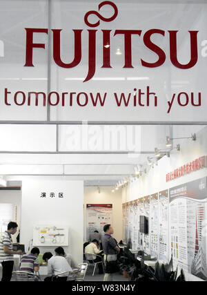 --FILE--People visit the stand of Fujitsu during an exhibition in Nanjing city, east China's Jiangsu province, 12 September 2014.   Fujitsu's presiden Stock Photo