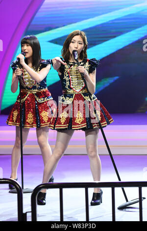 Mayu Watanabe, front, and Saya Kawamoto of Japanese girl group AKB48 perform at a fan meeting in Shanghai, China, 10 December 2016. Stock Photo