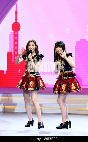 Mayu Watanabe, left, and Saya Kawamoto of Japanese girl group AKB48 perform at a fan meeting in Shanghai, China, 10 December 2016. Stock Photo