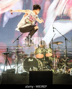 A member of Japanese rock band One Ok Rock performs at a concert 
