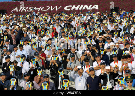 Visitors watch a flight performance during the 11th China International Aviation and Aerospace Exhibition, also known as Airshow China 2016, in Zhuhai Stock Photo