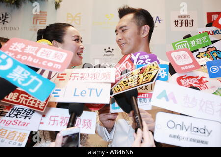 Canadian actress Christy Chung, left, and Chinese actor Zhang Lunshuo look into each other's eyes as they are interviewed during their wedding ceremon Stock Photo