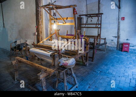 View of an old-fashioned loom at a dyehouse in Wuzhen town, Tongxiang city, east China's Zhejiang province, 10 April 2015.    On both sides of slabsto Stock Photo