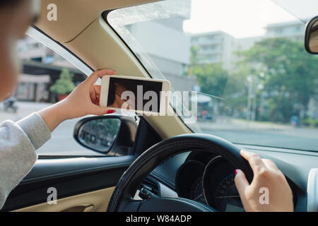 woman sit in modern car in front of dashboard Stock Photo