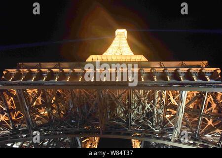 The half-sized copy of Eiffel Tower is illuminated at Tianducheng, a small Chinese community replicating Paris, in Hangzhou city, east China's Zhejian Stock Photo
