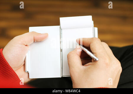Picture of man holding a notebook in hand. Isolated on white background. Stock Photo