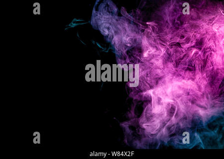 Frozen abstract movement of  explosion smoke multiple blue and pink colors on black background. Background from the smoke of vape Stock Photo