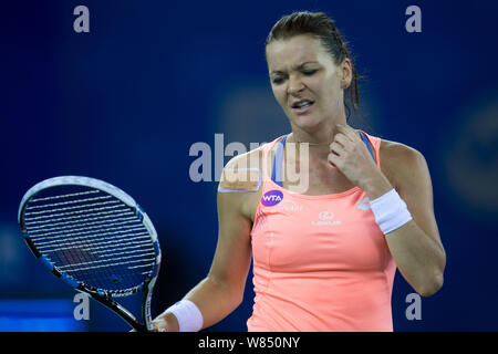 Agnieszka Radwanska of Poland reacts as she competes against Svetlana Kuznetsova of Russia in their women's singles quarterfinal match during the WTA Stock Photo
