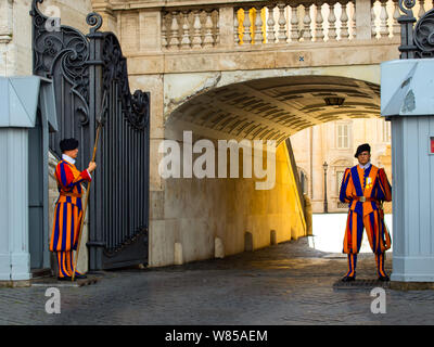 VATICAN CITY, ROME - APRIL 29, 2019: Traditional Papal Swiss guard with halberd in front of a sentry-box, outside of the St. Peter's Basilica Stock Photo