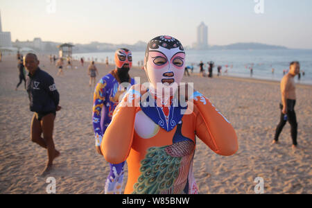 Chinese women wearing facekinis are pictured at a beach resort in Qingdao  city, east China's Shandong province, 5 July 2016. Summer is here! With te  Stock Photo - Alamy
