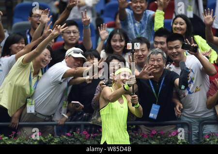 Lucie Safarova of Czech Republic takes selfies with fans after defeating Varvara Lepchenko of the United States during their women's singles of the 20 Stock Photo